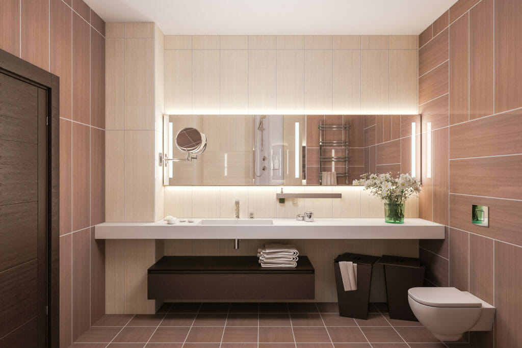 Interior design of a modern bathroom with a large custom vanity mirror. 