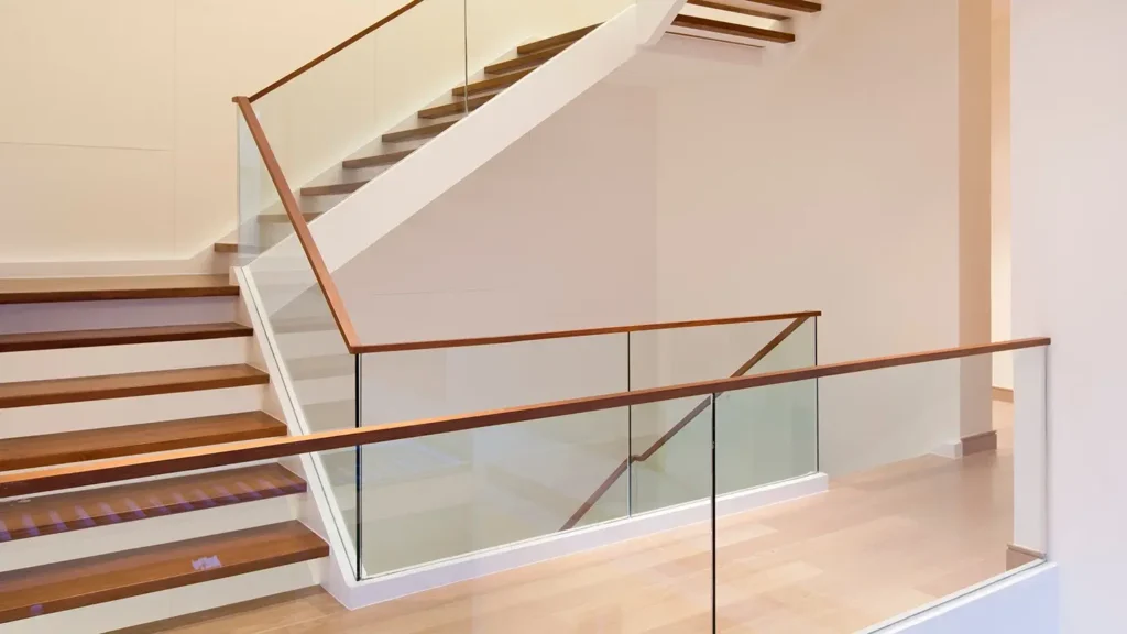 A stairway with a glass railing in the middle of office building