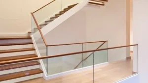 A stairway with a glass railing in the middle of office building