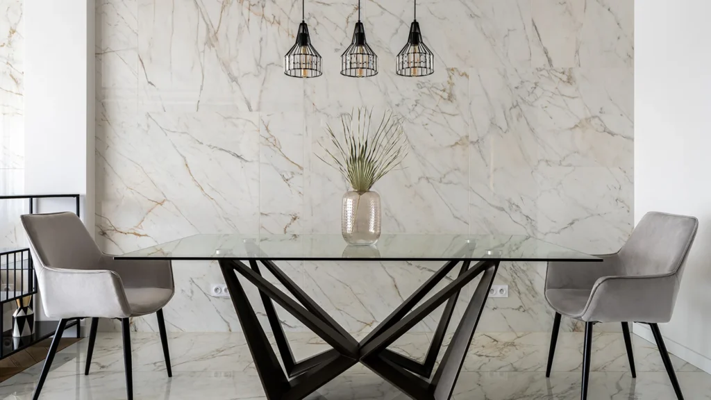 A modern glass dining table with two chairs